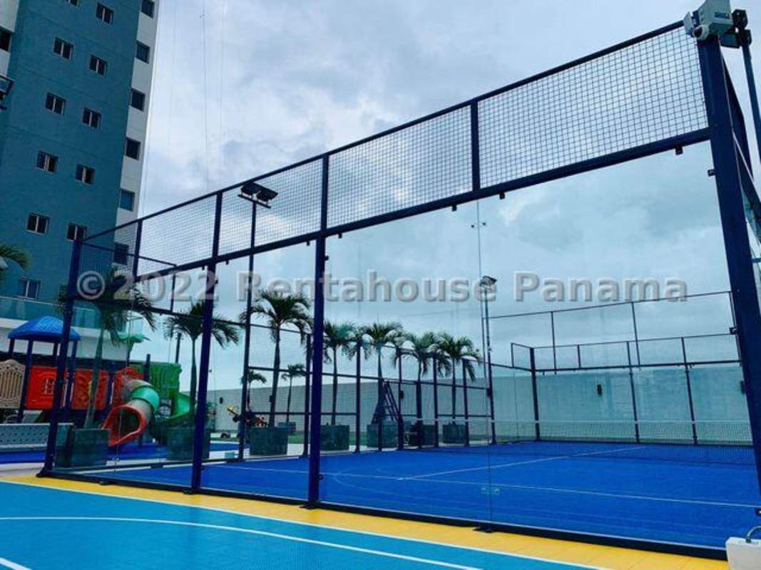 Bright lobby with palm tree views, beige sofas, glass walls in Ten Tower Panama