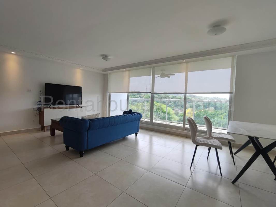 Open living dining with blue sofa, TV, large windows Clayton Park II Panama