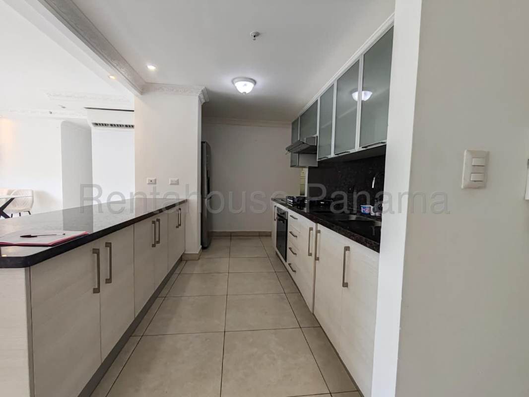 Modern kitchen granite countertop, built-in oven, refrigerator in Clayton Park II apartment Panama