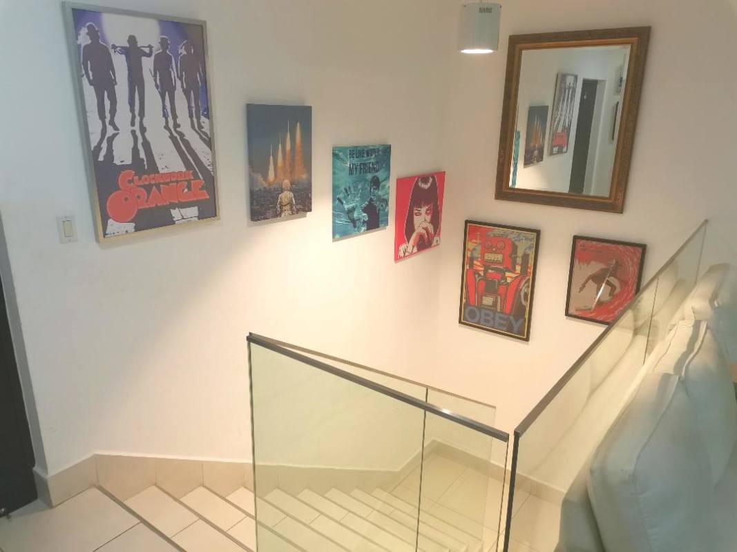 Contemporary staircase with glass railing and colorful wall art PH Castellamare Costa del Este