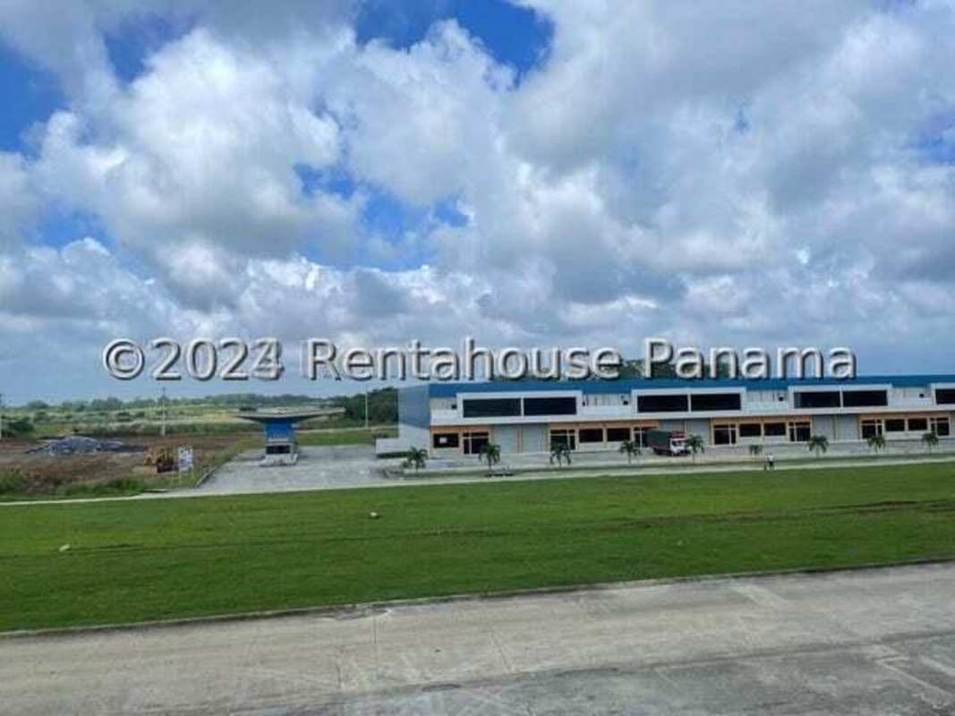 Modern industrial park warehouse facade with multiple bays and parking area in Pacora Panama