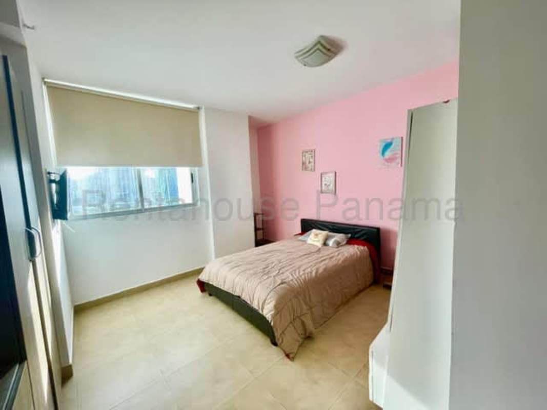 Bedroom with pink wall accent, large window, contemporary style Panama