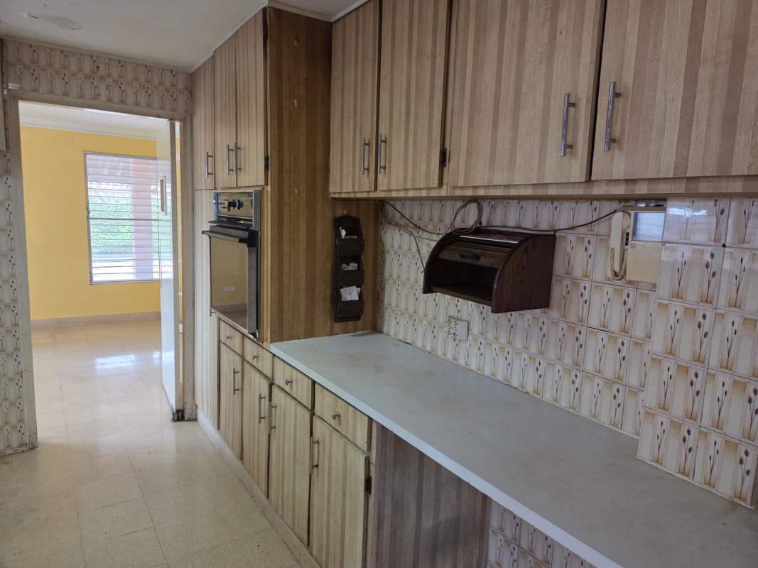 Interior staircase with ornate classical mural and wrought iron railings in La Alameda Panama house.