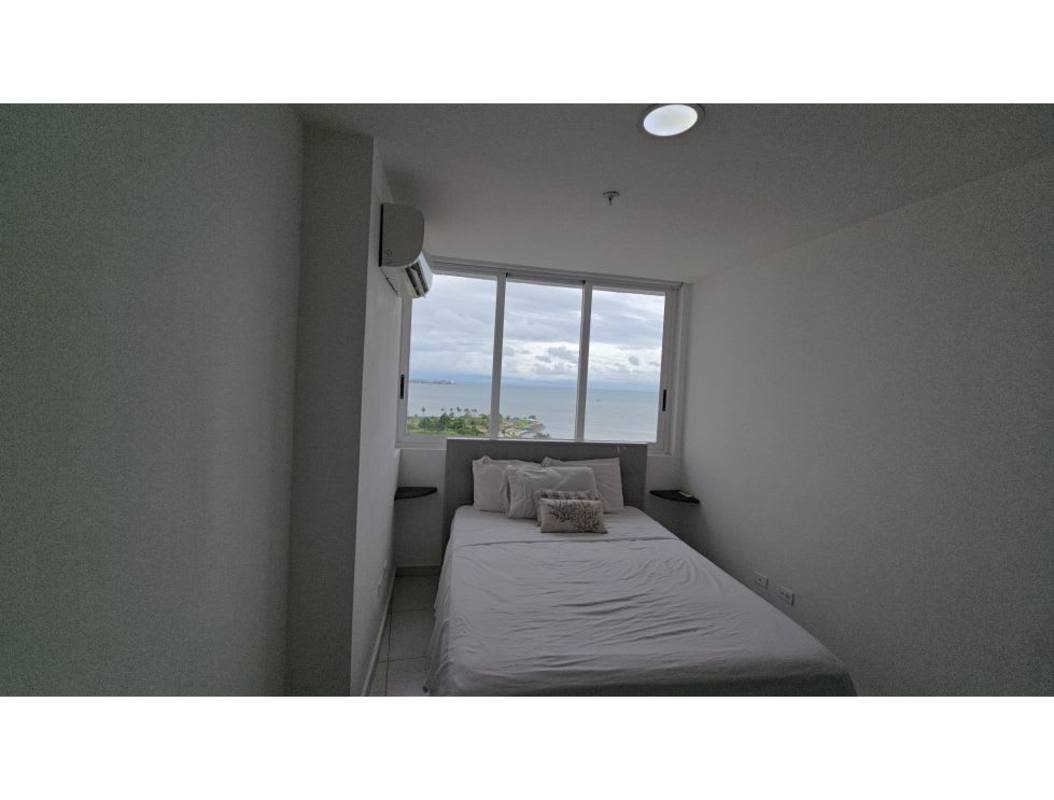 Bedroom with floor-to-ceiling window and ocean view condo Bay View Tower Panama City