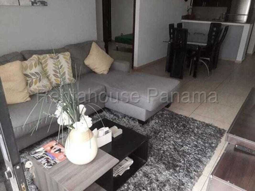 Dining room with glass table and open kitchen in PH Altavista Tower Panama