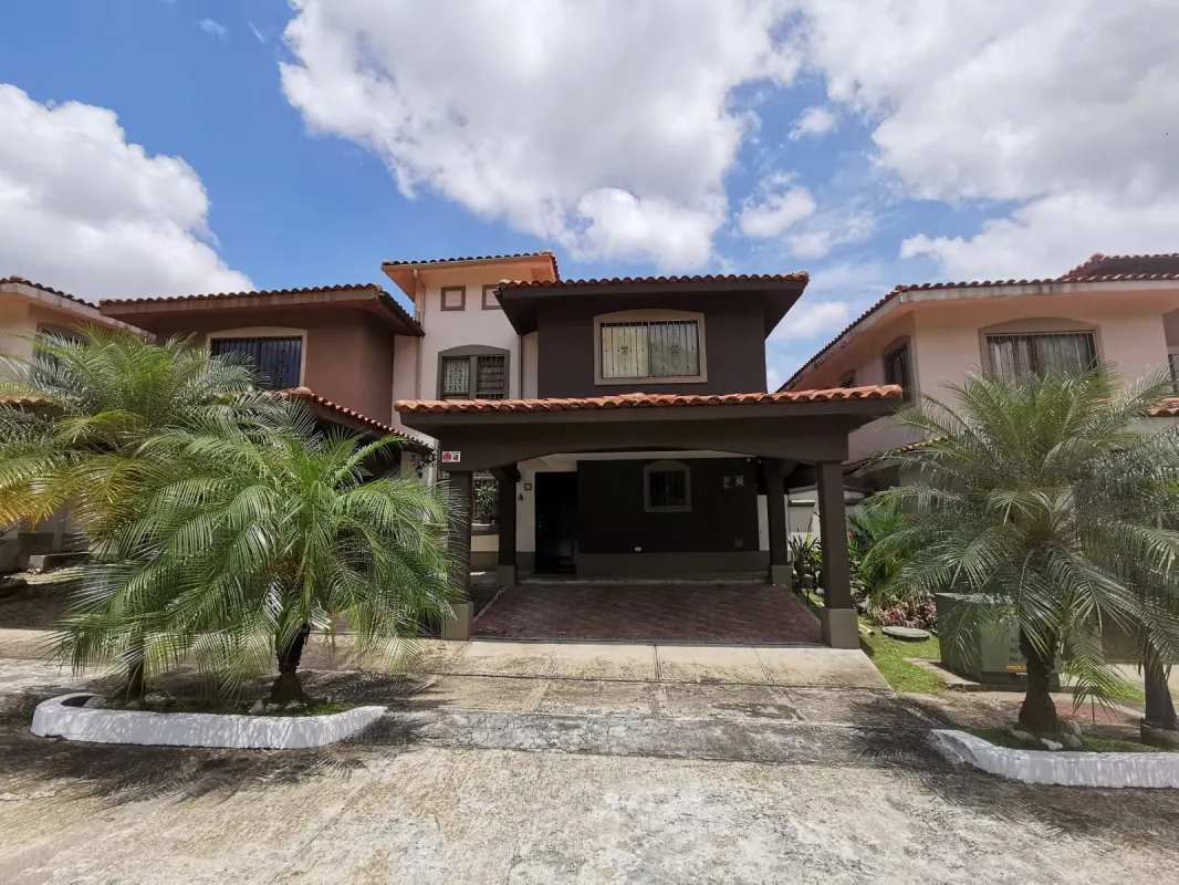 Exterior view two-story Mediterranean home with terrace, parking, palm trees in Milla 8 Panama for rent
