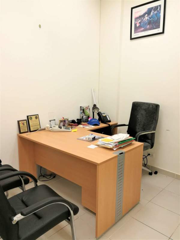 Private office in commercial unit with wooden desk, black chairs, tiled floor at Brisas del Golf Panama