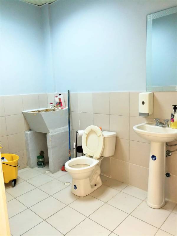 Bathroom with toilet, pedestal sink and utility wash basin inside Brisas 507 Plaza Panama City