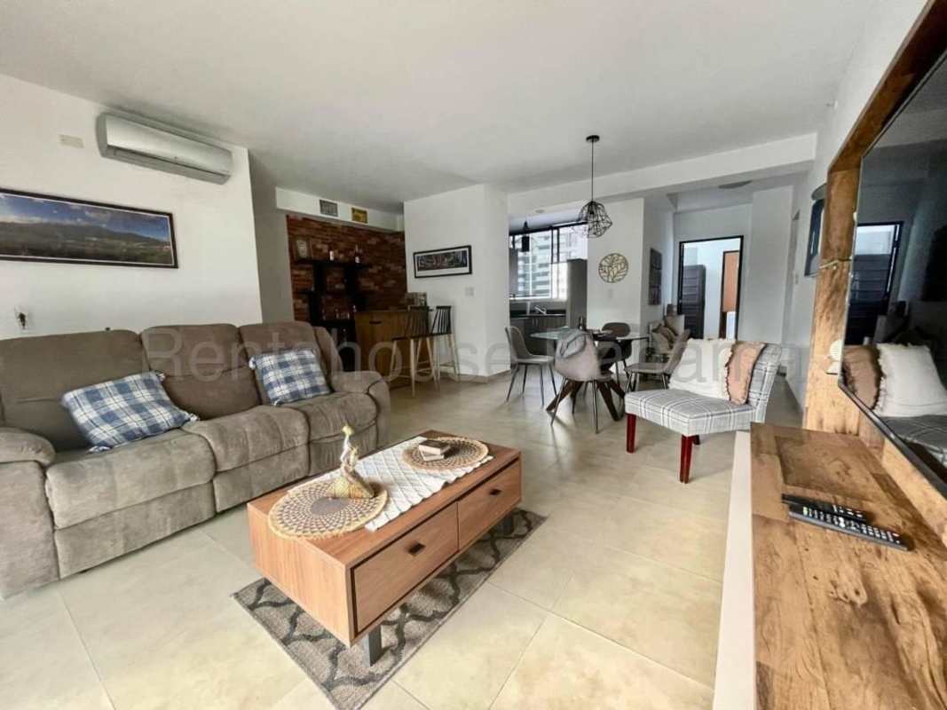 Open living dining area with floor-to-ceiling windows at PH Calle 50 Obarrio Panama City