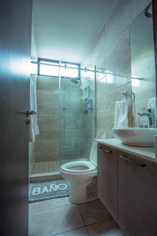 Modern bathroom with glass shower enclosure and vanity PH Torres de Chanis Panama City