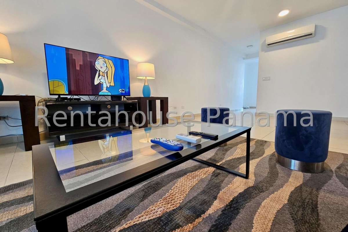Bright living room with large windows offering Pacific Ocean views at Oasis on the Bay Punta Pacifica