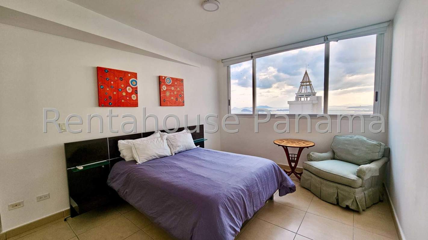 Elegant bedroom with large window and ocean view in Oasis on the Bay Panama City