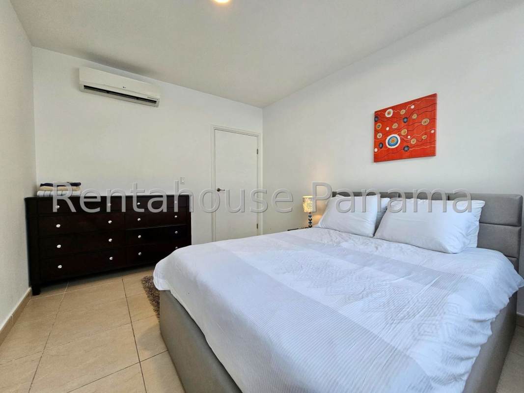 Modern bathroom with glass shower doors, large mirror at Oasis on the Bay Panama