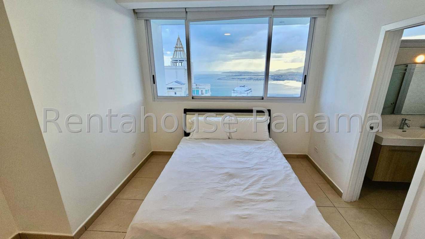 Stylish bathroom with frameless shower enclosure in Punta Pacifica apartment