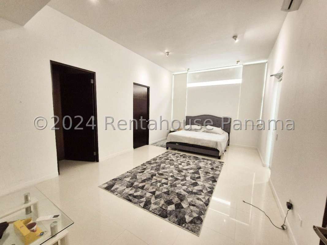 Covered terrace with wicker furniture garden views minimalist home for rent Panama City