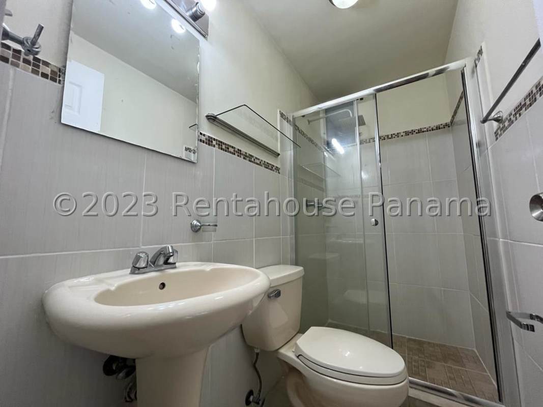 Contemporary bathroom with glass-enclosed shower and pedestal sink in PH Splendor By The Park Carrasquilla Panama City