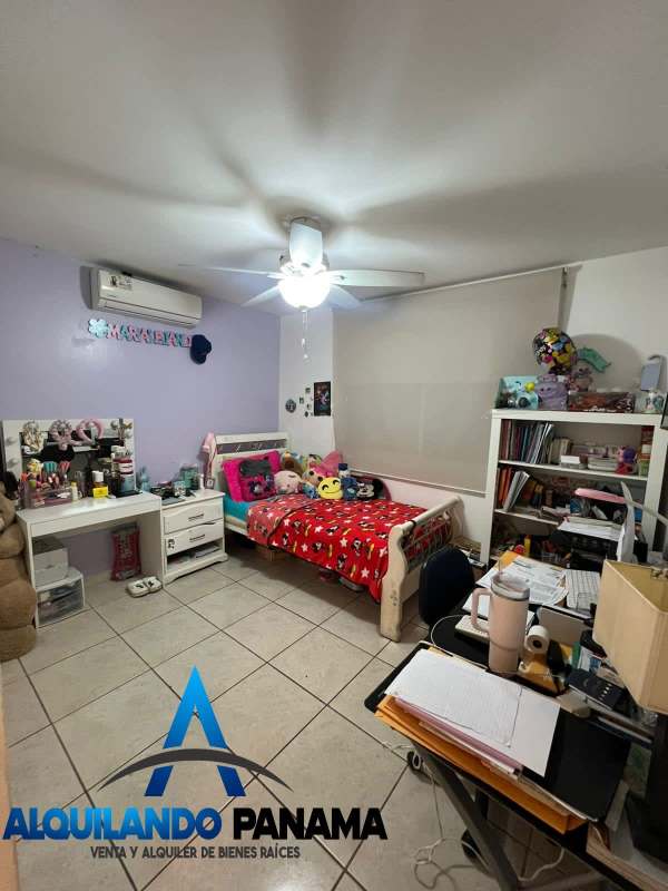Bedroom with study corner, single bed, vanity setup, ceiling fan in Brisas del Golf house Panama