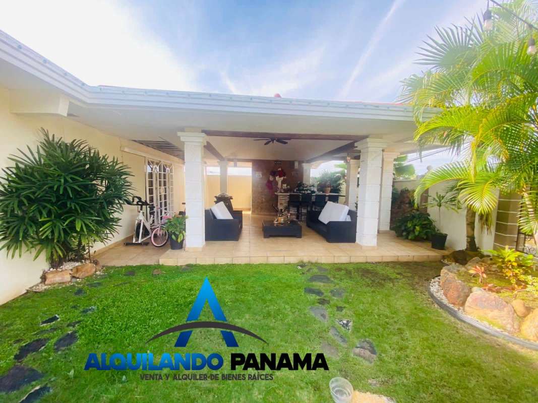 Spacious covered patio with outdoor seating and garden views at Brisas del Golf house in Panama