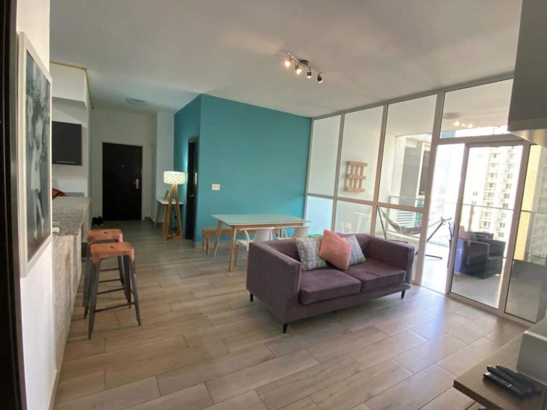 Bright living dining area with access to balcony overlooking the city in PH Quadrat Panama