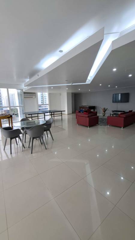 Reception lobby with white sofas, glossy tile floor and art in PH Quadrat Panama City