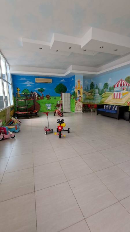 Outdoor playground club with artificial turf and playsets at PH Quadrat Panama