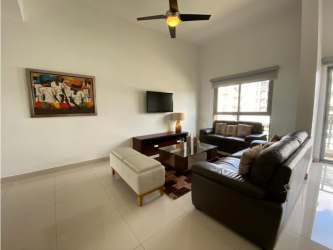 Living room with leather sofas, large window and modern decor in PH Soleo apartment Panama Pacifico