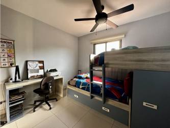 Indoor staircase with accent wall art and chandelier in Woodlands Panama Pacifico house