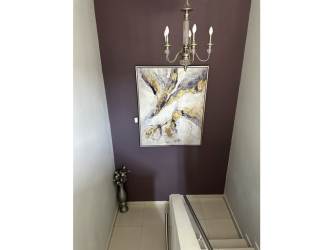 Spacious master bedroom with workspace, blue accent wall, windows in Woodlands Panama Pacifico