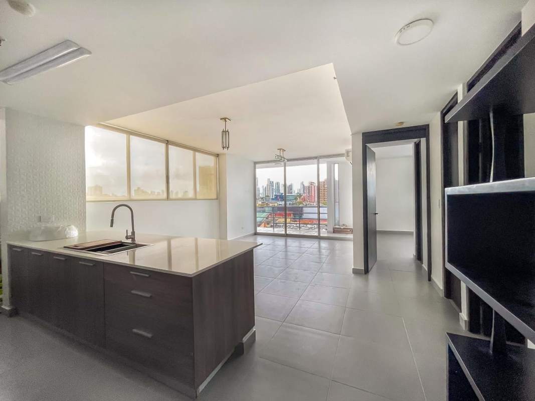 Modern open living area and kitchen with island and window views in PH Trio El Carmen Bella Vista Panama City