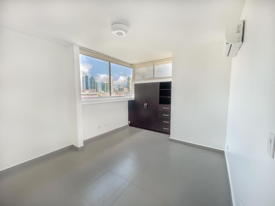 Contemporary living room with sliding doors to balcony, tiled floors at PH Trio Panama City