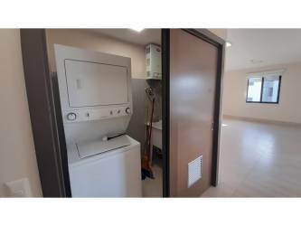 Open living and dining room with balcony access and garden views in River Valley Panama Pacifico