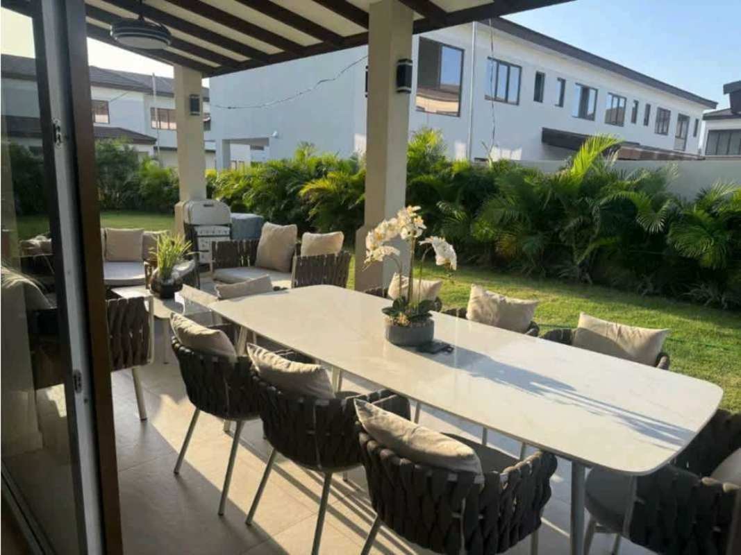 Covered terrace with outdoor seating dining area and landscaped backyard Santa Maria Panama for rent
