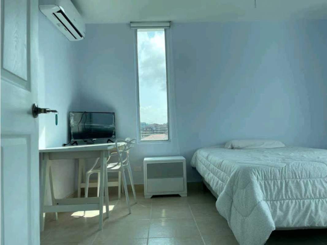 Bedroom with AC window desk television minimalist style furnished rental Clayton Park Panama