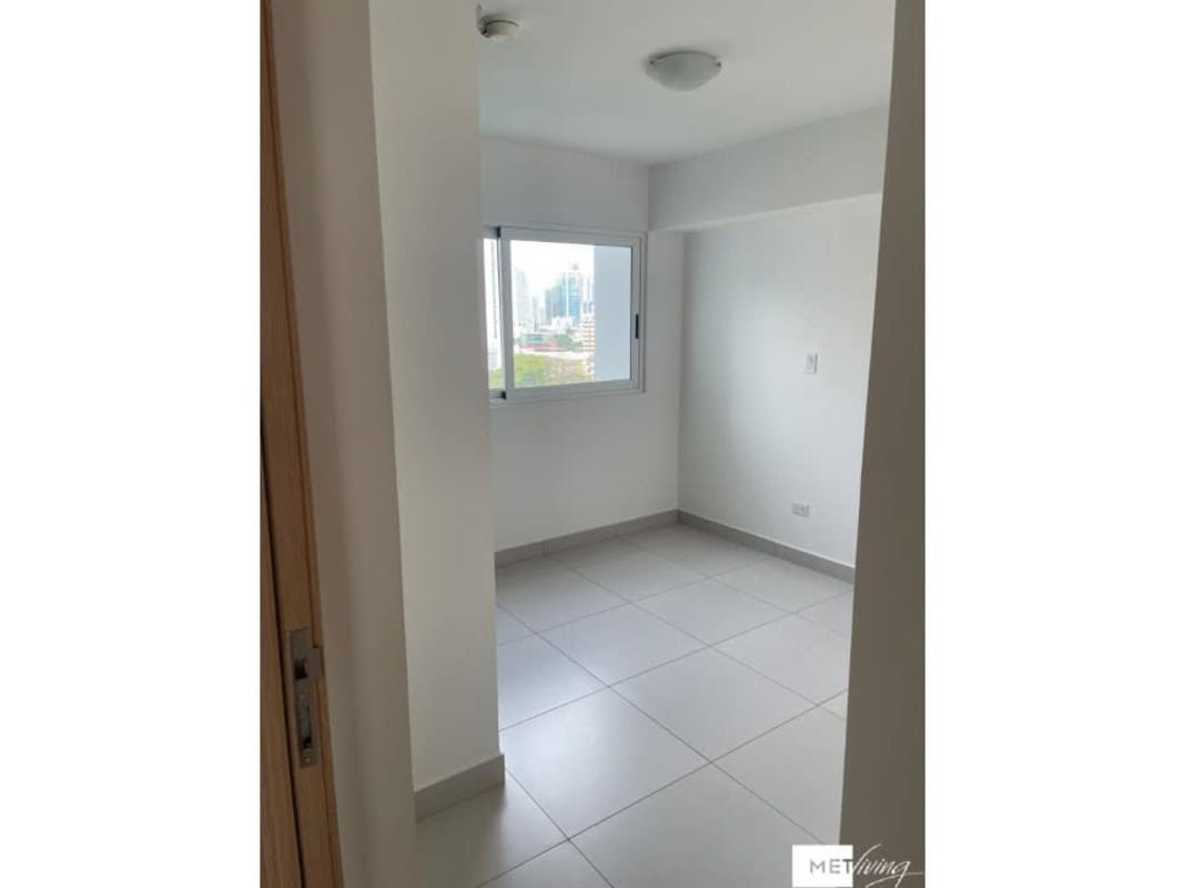 Balcony with views of city skyline and lush Parque Omar in PH Altos del Golf Panama City