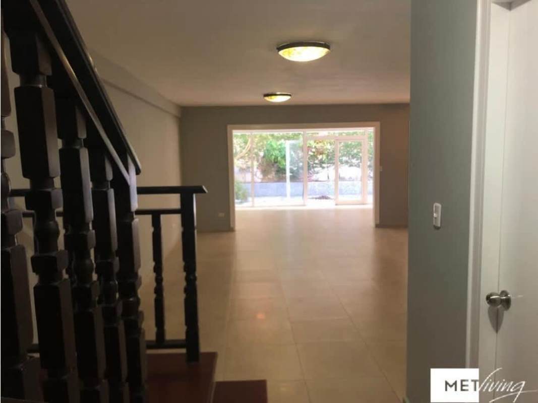 Spacious living room, sliding glass doors, ceramic tile flooring, wooden staircase, Betania Panama