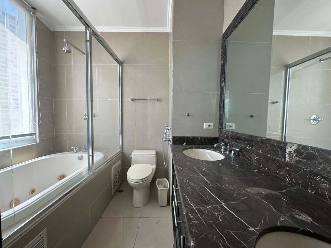 Kitchen with granite countertops and wood cabinetry in PH Titanium San Francisco Panama for sale