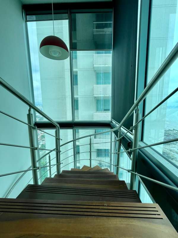 Stylish staircase and large panorama windows with ocean view in PH Loft Four41 condo Panama