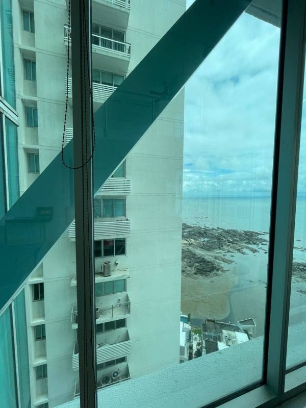 Luxury loft living space with tall windows and ocean views at PH Loft Four41 Punta Pacifica