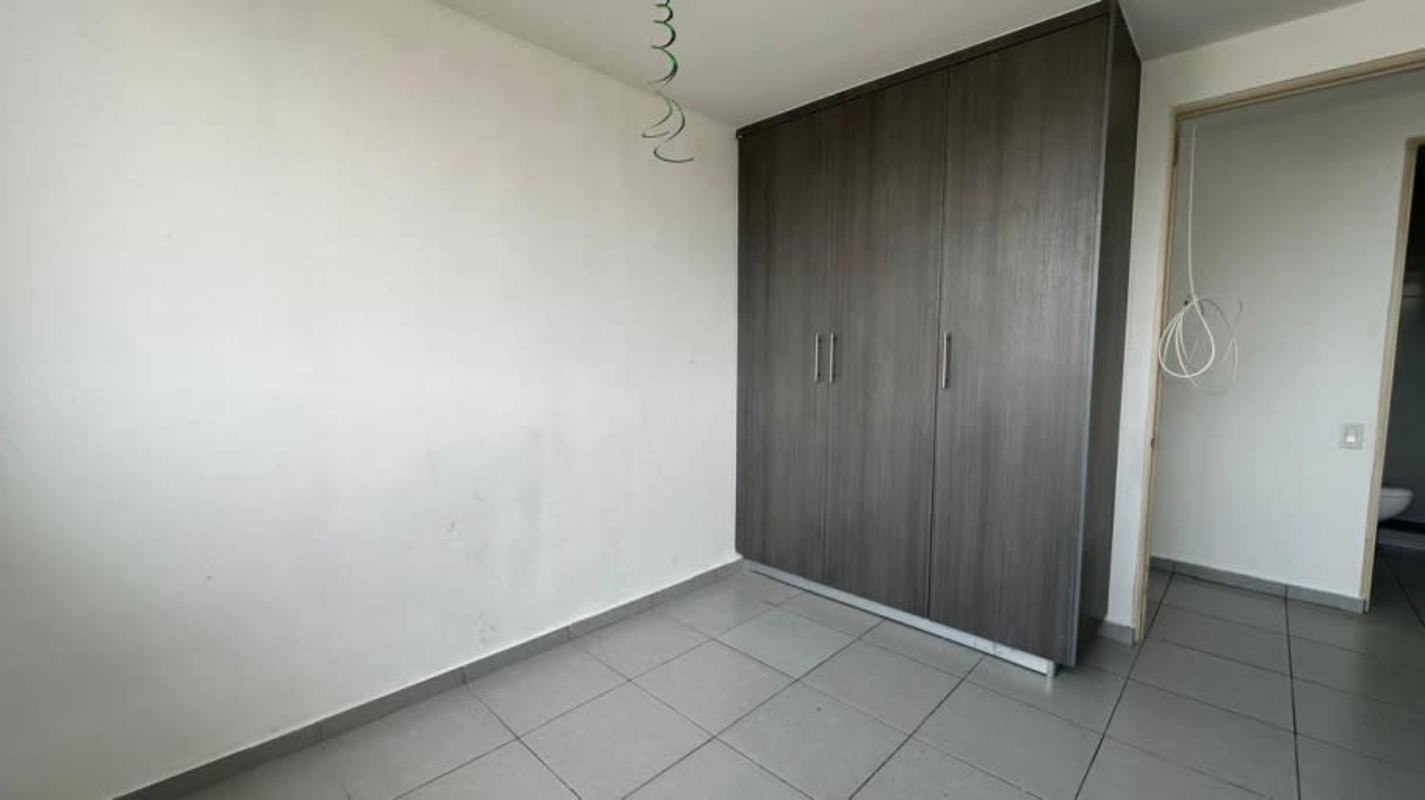Bedroom with white walls, ceramic tile floor, and built-in closet at Condado del Rey Panama