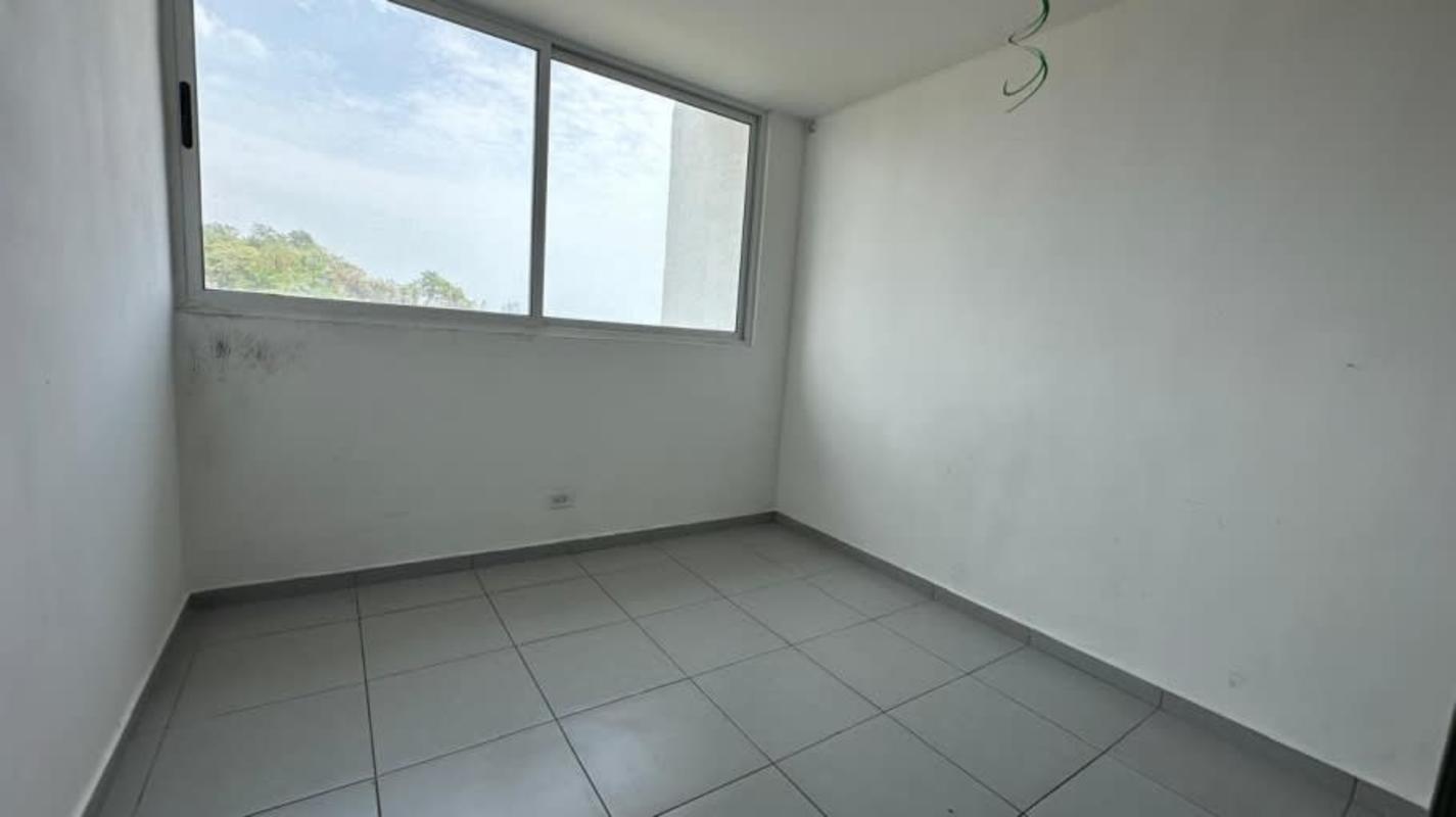 Bedroom with large window, tile floors in affordable Condado del Rey apartment Panama