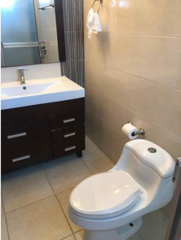 Living room with gray sofa, big window balcony forest view PH Clayton Park Panama City