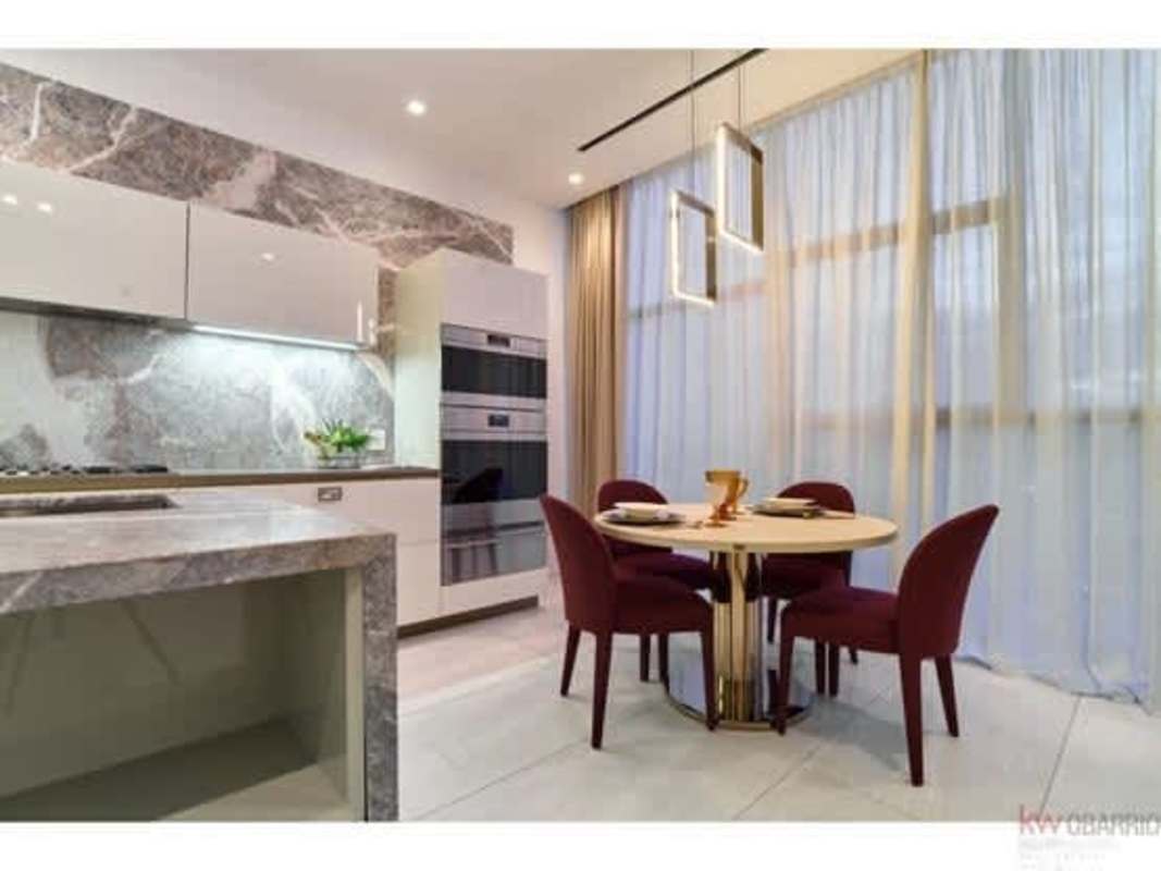 Kitchen and dining with marble details, modern appliances PH La Maison Costa del Este Panama