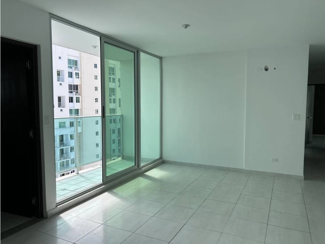 Bright living room with large sliding glass doors to balcony overlooking Panama City PH Trinity Tower