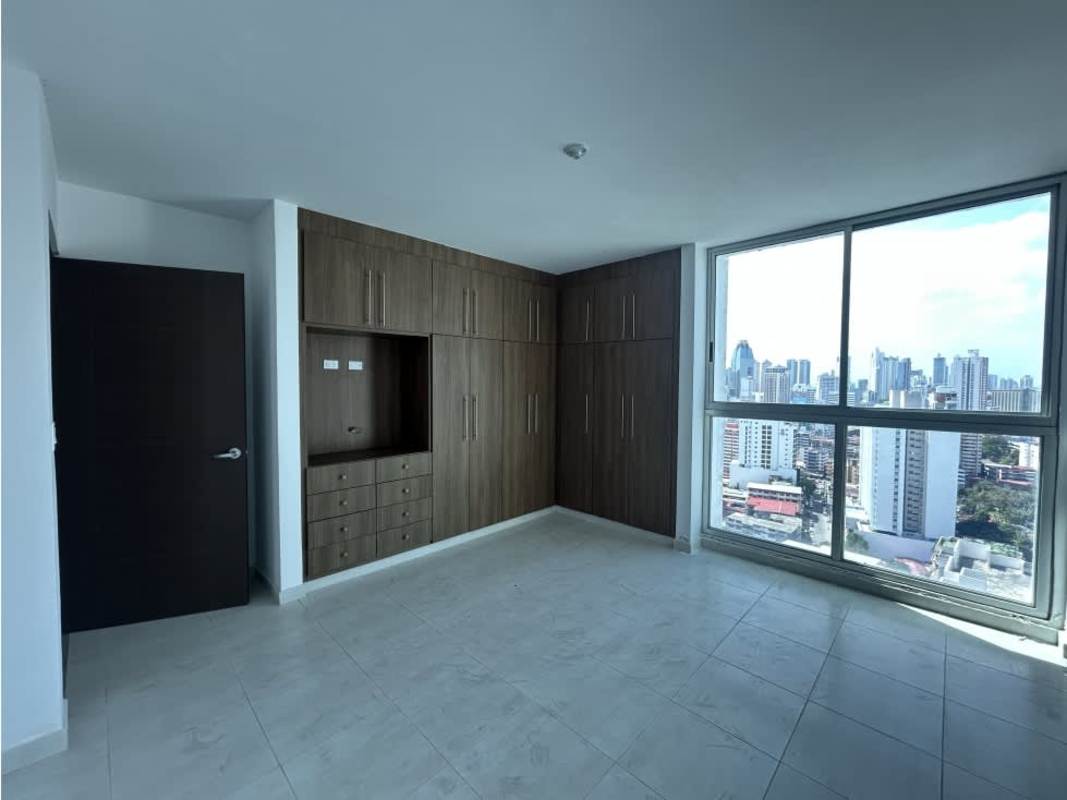 Bright modern bedroom with built-in wooden wardrobe city skyline window PH Trinity Tower