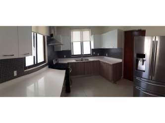 Modern kitchen with granite countertops, appliances, modern cabinetry in River Valley Panama Pacifico