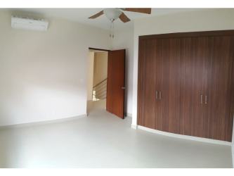 Contemporary bathroom with double vanity sinks, large mirror, glass walk-in shower in River Valley Panama Pacifico