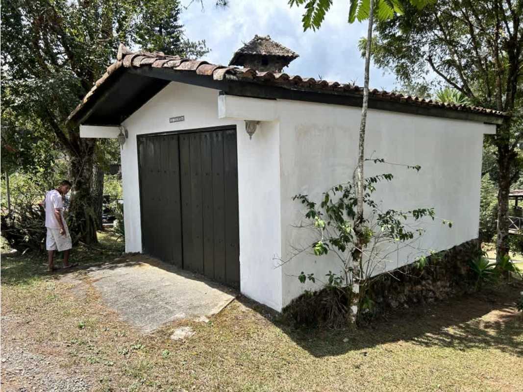 Rustic two-story cabin with balcony and stone walls in Cerro Azul mountain forest Panama