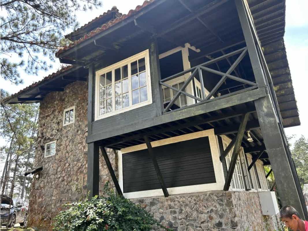 Stone and wood rustic cabin with balcony in mountain forest Cerro Azul