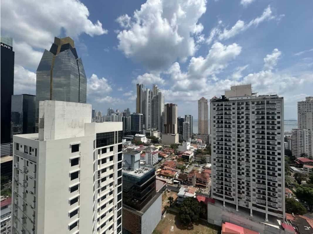 Aerial view of PH Seawaves tower with city and coast in Bella Vista Panama City