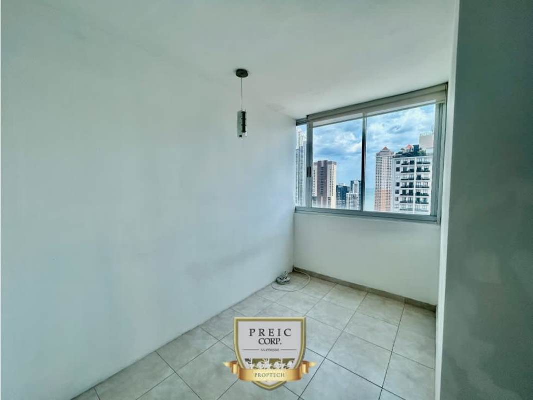 Bright bedroom with large windows and built-in dark wardrobe in Seawaves Panama